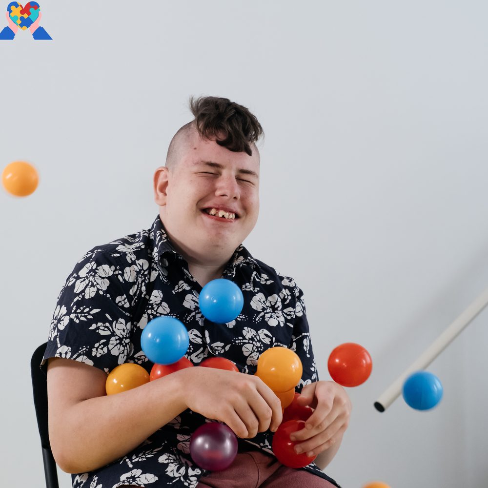 A young autistic person laughing joyfully